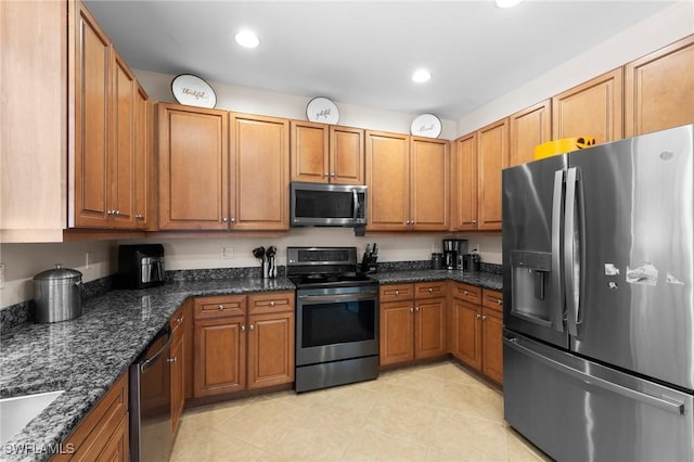 8364 Laurel Lakes Blvd, Naples, FL 34119 - kitchen featuring stainless steel appliances, brown cabinetry, light tile patterned floors, and recessed lighting