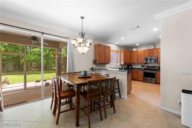 8364 Laurel Lakes Blvd, Naples, FL 34119 - dining space featuring light tile patterned floors, recessed lighting, and ornamental molding