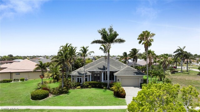 4009 Chiquita Blvd S, Cape Coral, FL 33914 - ranch-style house with a garage, a front lawn, and driveway