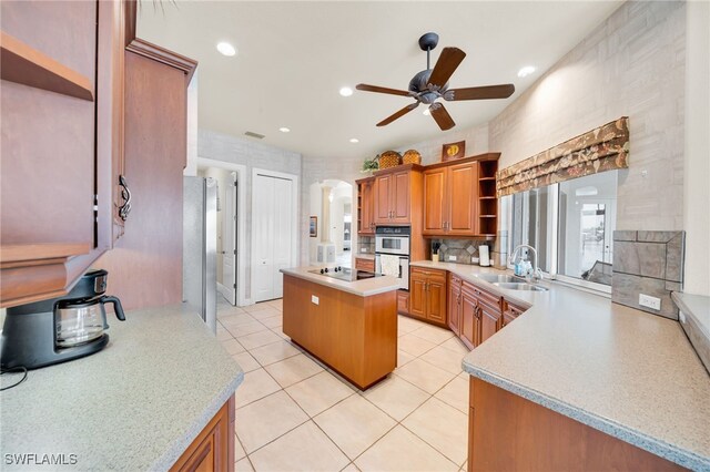4009 Chiquita Blvd S, Cape Coral, FL 33914 - kitchen featuring a sink, open shelves, a ceiling fan, a kitchen island, and light countertops