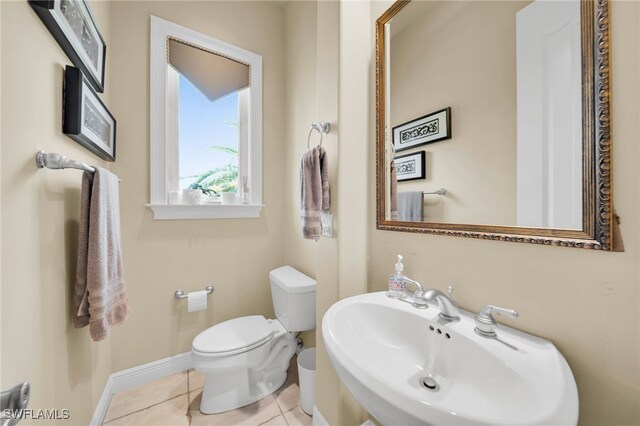 4009 Chiquita Blvd S, Cape Coral, FL 33914 - half bath featuring a sink, toilet, tile patterned floors, and baseboards
