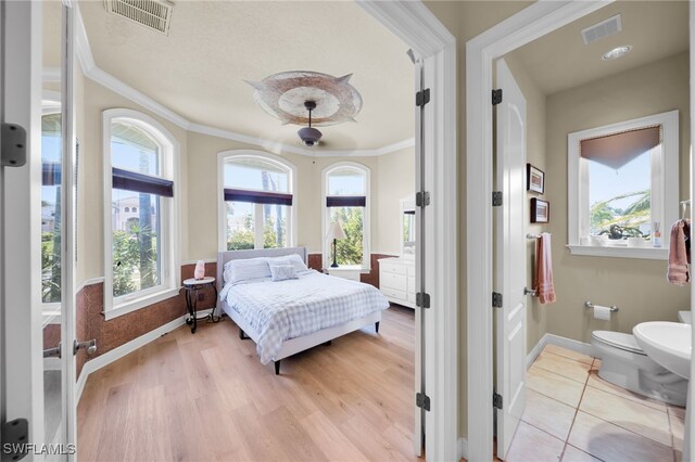4009 Chiquita Blvd S, Cape Coral, FL 33914 - bedroom featuring ornamental molding, baseboards, light wood-style floors, and ceiling fan