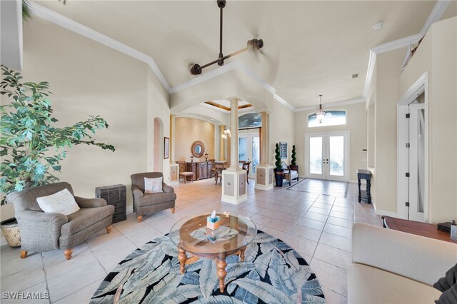 4009 Chiquita Blvd S, Cape Coral, FL 33914 - living room featuring arched walkways, french doors, ornate columns, light tile patterned floors, and crown molding