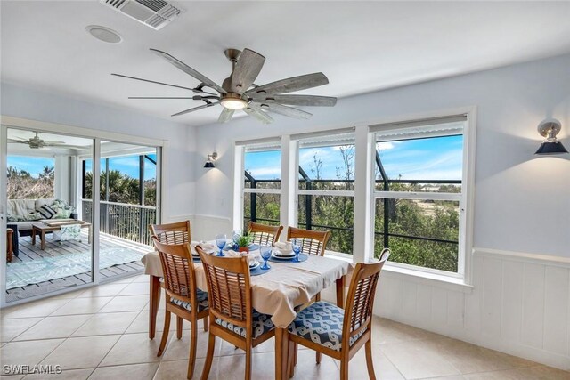 654 Sea Oats Dr, Sanibel, FL 33957 - dining area featuring ceiling fan, healthy amount of natural light, wainscoting, and light tile patterned floors