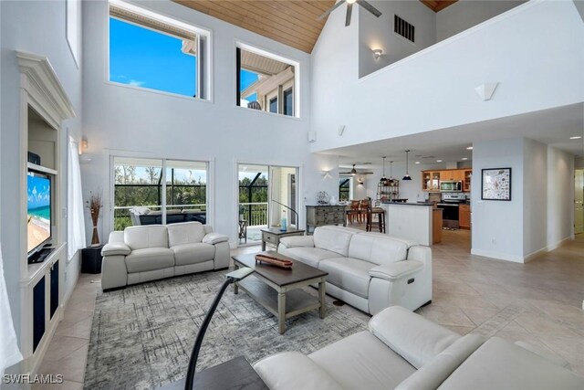 654 Sea Oats Dr, Sanibel, FL 33957 - living area with a ceiling fan, high vaulted ceiling, light tile patterned floors, wood ceiling, and baseboards