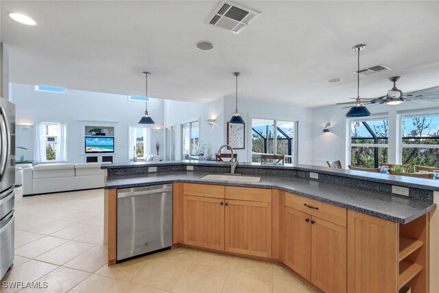 654 Sea Oats Dr, Sanibel, FL 33957 - kitchen featuring dishwasher, open floor plan, a sink, dark countertops, and light tile patterned floors