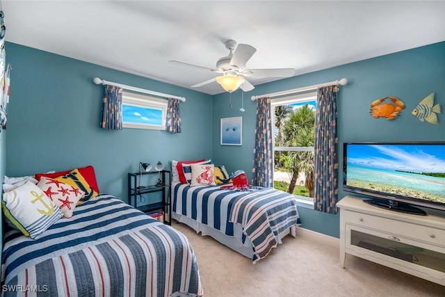 654 Sea Oats Dr, Sanibel, FL 33957 - bedroom with multiple windows, carpet floors, ceiling fan, and baseboards