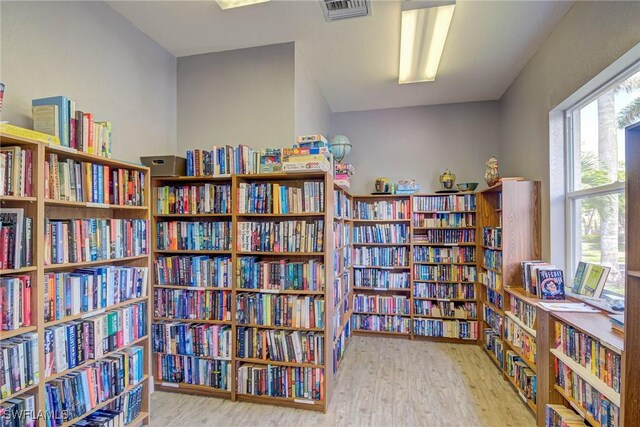 14931 Park Lake Dr Unit 209, Fort Myers, FL 33919 - living area featuring bookshelves and wood finished floors