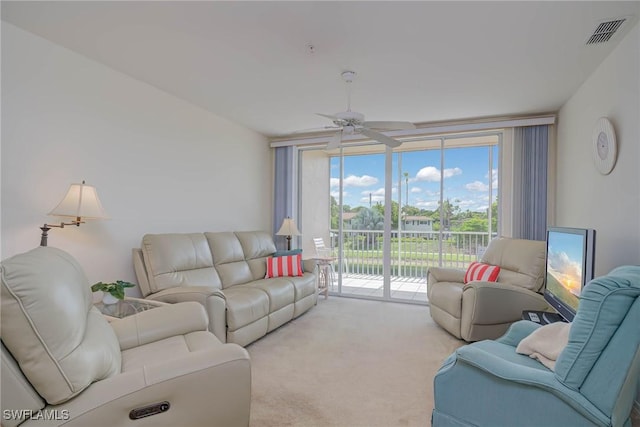 14931 Park Lake Dr Unit 209, Fort Myers, FL 33919 - living area with expansive windows, ceiling fan, carpet flooring, and plenty of natural light