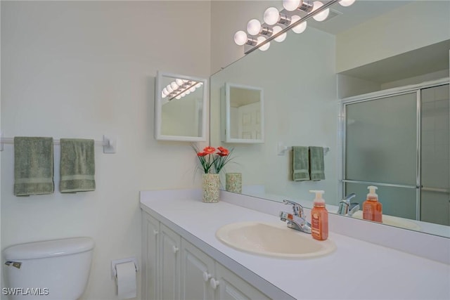 14931 Park Lake Dr Unit 209, Fort Myers, FL 33919 - bathroom featuring toilet, vanity, and an enclosed shower