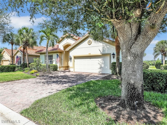 26527 Lucky Stone Rd, Bonita Springs, FL 34135 - view of front of house featuring stucco siding, a garage, driveway, and a tile roof
