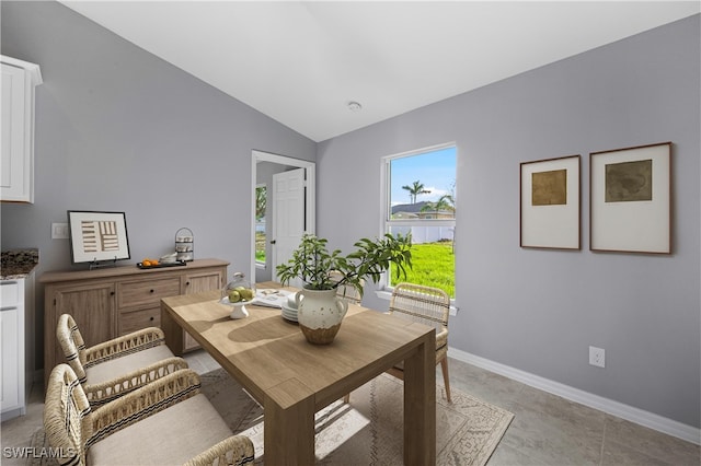 1716 NW 9th Pl, Cape Coral, FL 33993 - dining area with lofted ceiling, baseboards, and light tile patterned flooring