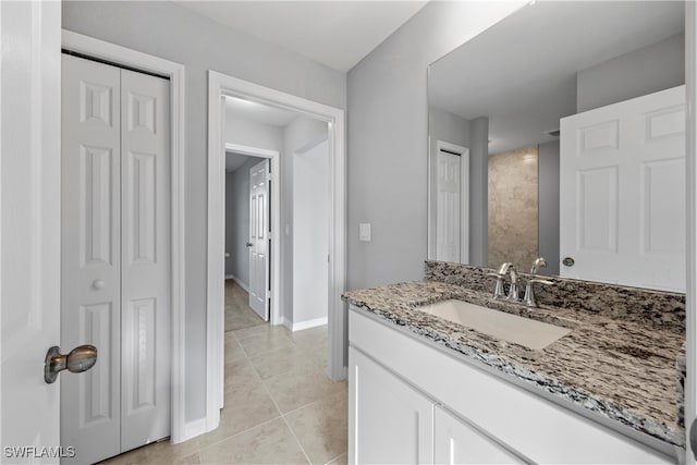 1716 NW 9th Pl, Cape Coral, FL 33993 - bathroom featuring a closet, vanity, baseboards, and tile patterned flooring