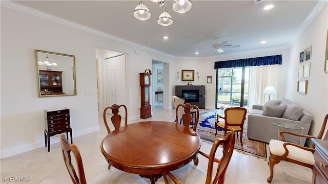 5872 Mayflower Way, Ave Maria, FL 34142 - dining space featuring a chandelier, light tile patterned floors, recessed lighting, crown molding, and a glass covered fireplace