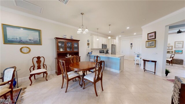 5872 Mayflower Way, Ave Maria, FL 34142 - dining space with crown molding, light tile patterned flooring, recessed lighting, baseboards, and a chandelier