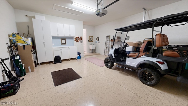 5872 Mayflower Way, Ave Maria, FL 34142 - garage featuring a garage door opener and a sink
