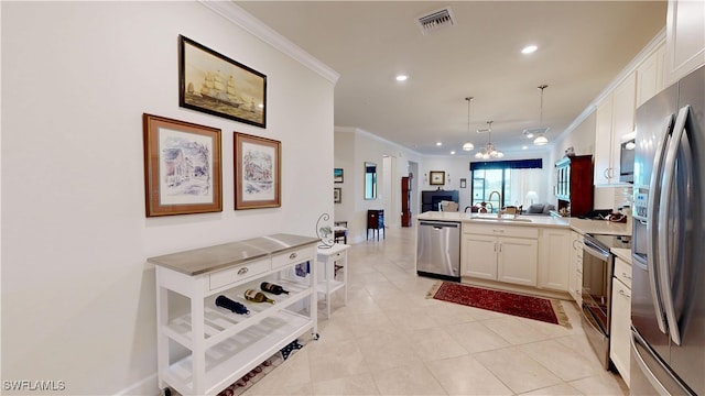 5872 Mayflower Way, Ave Maria, FL 34142 - kitchen with appliances with stainless steel finishes, open floor plan, a peninsula, ornamental molding, and recessed lighting