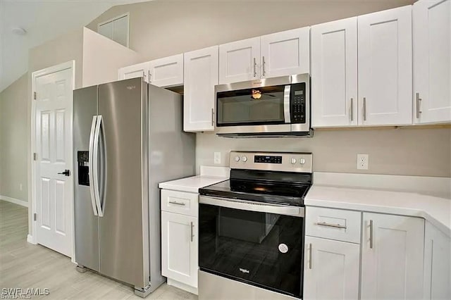 1143 Florence St E, Lehigh Acres, FL 33974 - kitchen with stainless steel appliances, light countertops, and white cabinetry