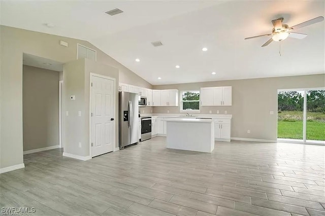 1143 Florence St E, Lehigh Acres, FL 33974 - kitchen featuring stainless steel appliances, vaulted ceiling, open floor plan, light countertops, and a ceiling fan