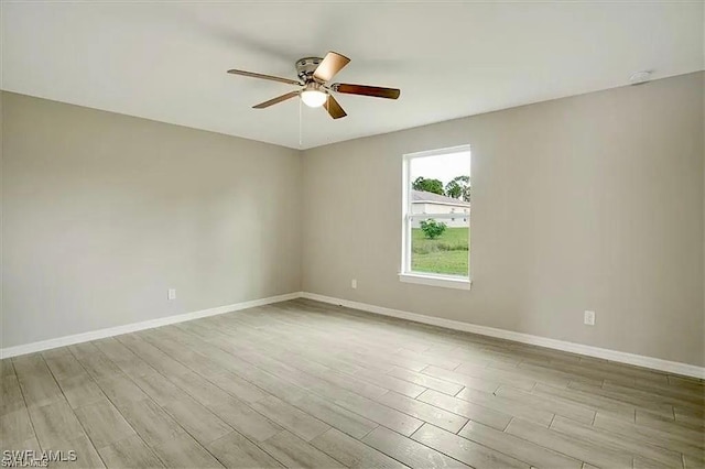 1143 Florence St E, Lehigh Acres, FL 33974 - empty room featuring ceiling fan, wood finished floors, baseboards, and a smoke detector