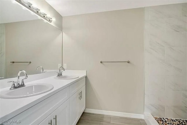 1143 Florence St E, Lehigh Acres, FL 33974 - full bathroom with double vanity and baseboards