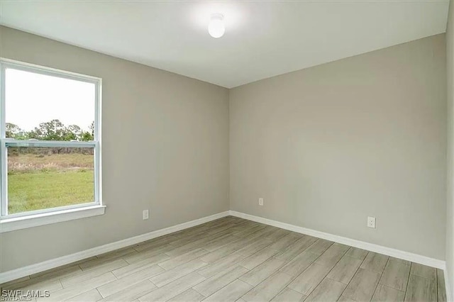 1143 Florence St E, Lehigh Acres, FL 33974 - empty room featuring wood finished floors and baseboards