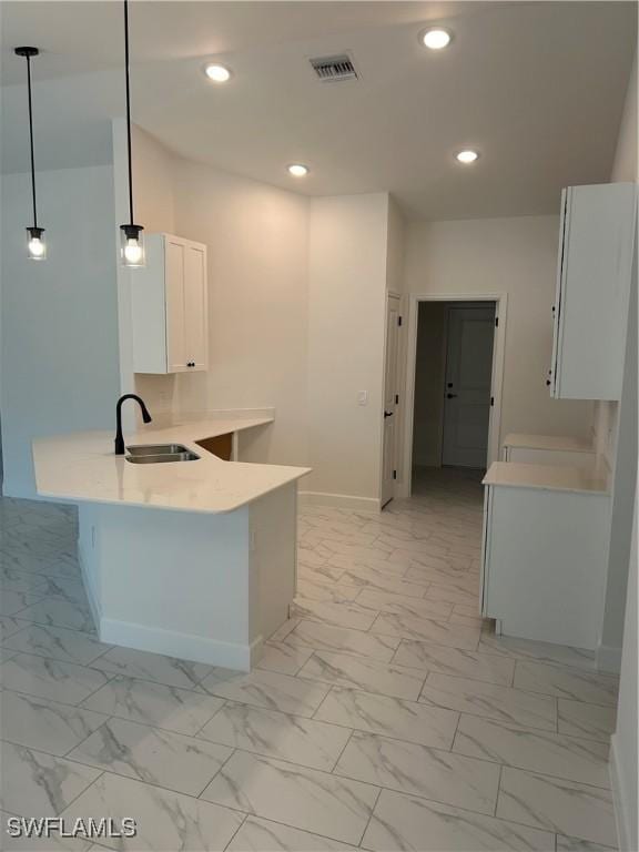 336 Ranchito Ave, Lehigh Acres, FL 33974 - kitchen featuring a sink, light marble finish flooring, a peninsula, baseboards, and recessed lighting