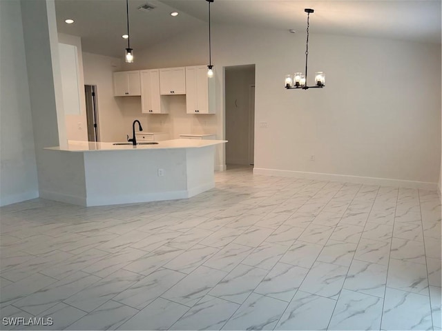 336 Ranchito Ave, Lehigh Acres, FL 33974 - kitchen with a sink, white cabinetry, baseboards, lofted ceiling, and recessed lighting