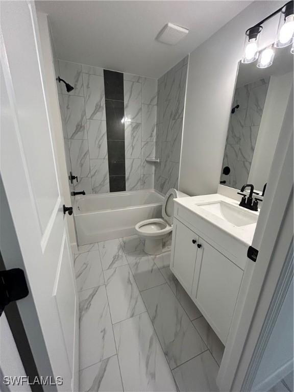 336 Ranchito Ave, Lehigh Acres, FL 33974 - full bath with marble look tiles, vanity, toilet, and bathing tub / shower combination