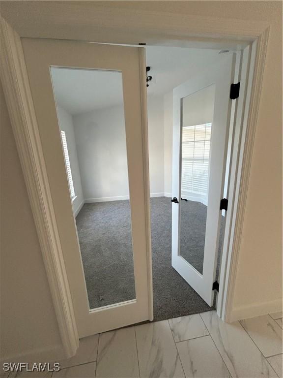 336 Ranchito Ave, Lehigh Acres, FL 33974 - carpeted spare room featuring baseboards and marble look tiles