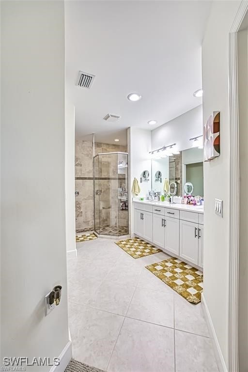 9232 Aviano Dr Unit 102, Fort Myers, FL 33913 - bathroom featuring double vanity, a shower stall, tile patterned floors, recessed lighting, and baseboards