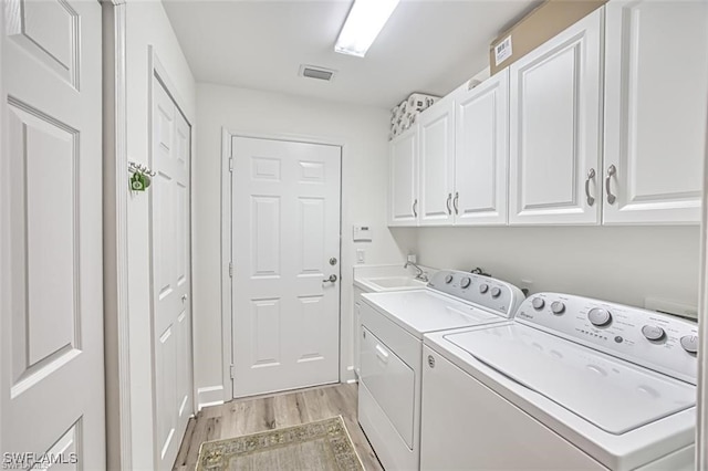 9232 Aviano Dr Unit 102, Fort Myers, FL 33913 - laundry area with cabinet space, light wood finished floors, and washing machine and dryer