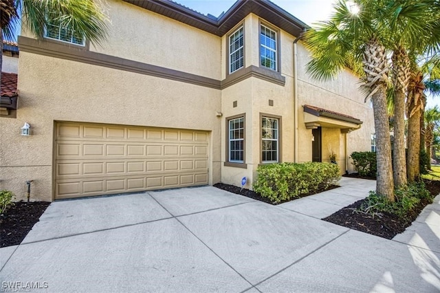 9232 Aviano Dr Unit 102, Fort Myers, FL 33913 - view of front of property featuring stucco siding, an attached garage, and driveway