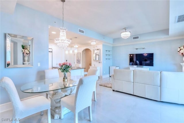 9115 Strada Pl Unit 5317, Naples, FL 34108 - dining room featuring a chandelier, arched walkways, and baseboards