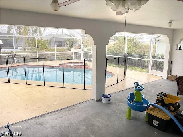 215 SE 1st Pl, Cape Coral, FL 33990 - view of pool with a pool with connected hot tub, glass enclosure, and a patio