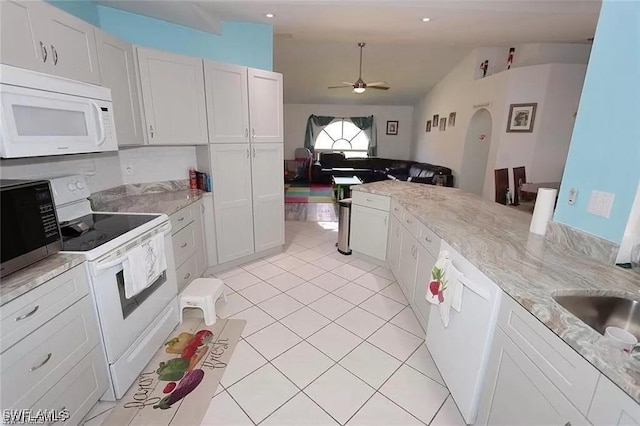 215 SE 1st Pl, Cape Coral, FL 33990 - kitchen with white appliances, ceiling fan, lofted ceiling, light tile patterned floors, and white cabinets
