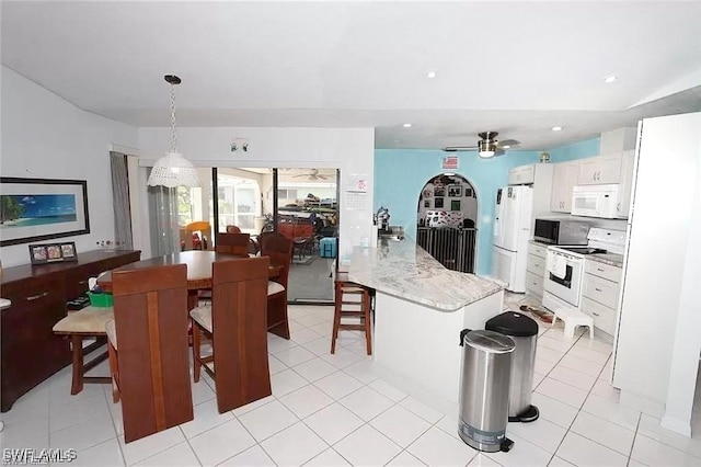 215 SE 1st Pl, Cape Coral, FL 33990 - kitchen featuring white appliances, a ceiling fan, white cabinetry, a kitchen breakfast bar, and recessed lighting