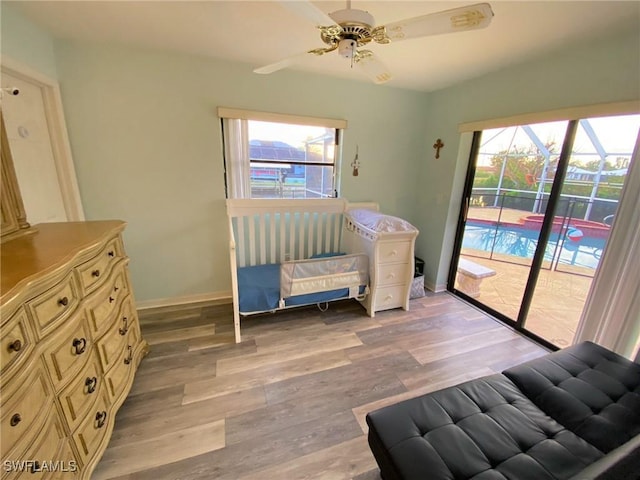 215 SE 1st Pl, Cape Coral, FL 33990 - bedroom with access to exterior, multiple windows, light wood-type flooring, and baseboards