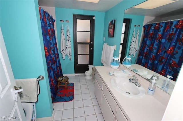215 SE 1st Pl, Cape Coral, FL 33990 - bathroom featuring tile patterned floors, vanity, toilet, baseboards, and a shower with shower curtain