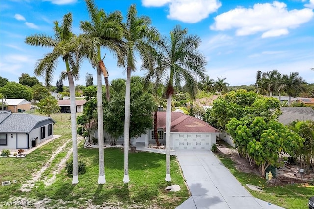 1717 43rd St SW, Naples, FL 34116 - view of front of house featuring a garage, driveway, and a front lawn