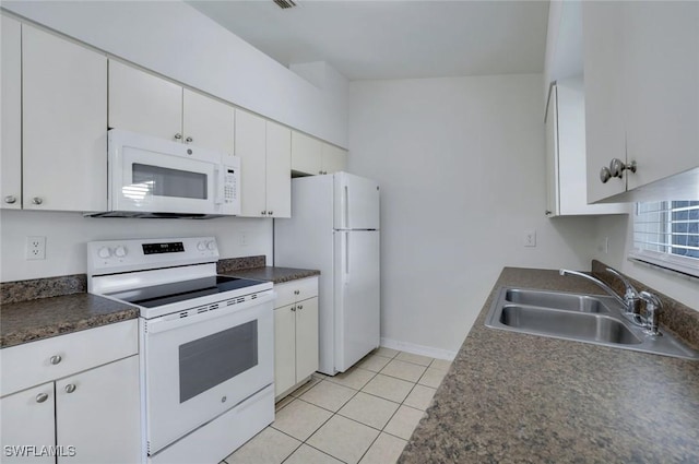 1717 43rd St SW, Naples, FL 34116 - kitchen featuring white appliances, a sink, light tile patterned floors, white cabinetry, and dark countertops