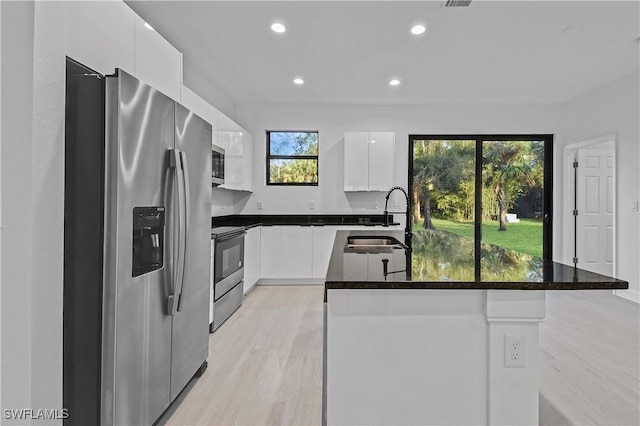 618 Sheldon Ave, Lehigh Acres, FL 33936 - kitchen with stainless steel appliances, a sink, modern cabinets, white cabinetry, and light wood-style flooring