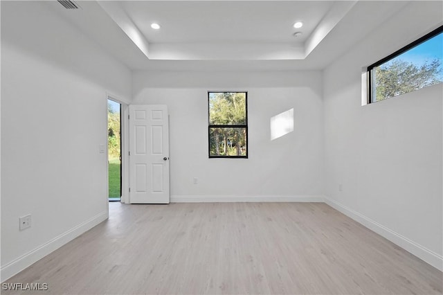 618 Sheldon Ave, Lehigh Acres, FL 33936 - spare room featuring light wood-style flooring, a raised ceiling, baseboards, and recessed lighting