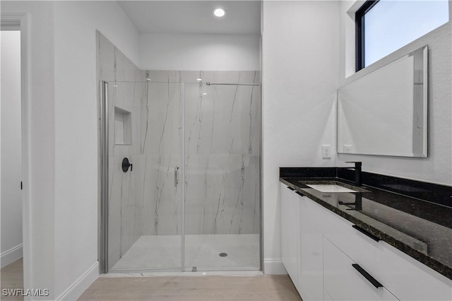 618 Sheldon Ave, Lehigh Acres, FL 33936 - bathroom with a marble finish shower, vanity, baseboards, wood finished floors, and recessed lighting