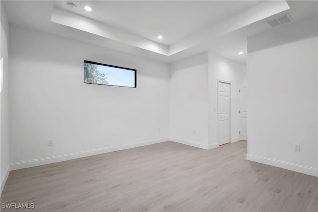 618 Sheldon Ave, Lehigh Acres, FL 33936 - unfurnished room featuring a tray ceiling, light wood-type flooring, recessed lighting, baseboards, and a smoke detector