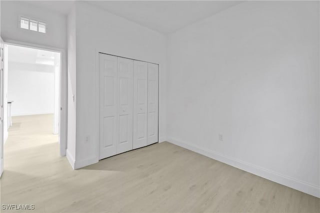 618 Sheldon Ave, Lehigh Acres, FL 33936 - unfurnished bedroom with light wood-type flooring, baseboards, and a closet
