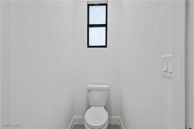 618 Sheldon Ave, Lehigh Acres, FL 33936 - bathroom with a textured wall, baseboards, and toilet