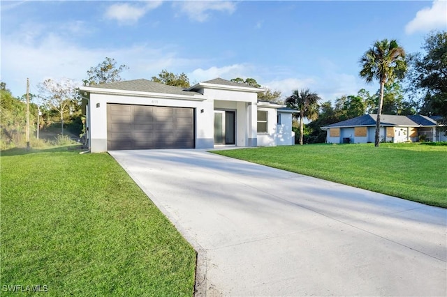 618 Sheldon Ave, Lehigh Acres, FL 33936 - prairie-style home with driveway, an attached garage, a front lawn, and stucco siding