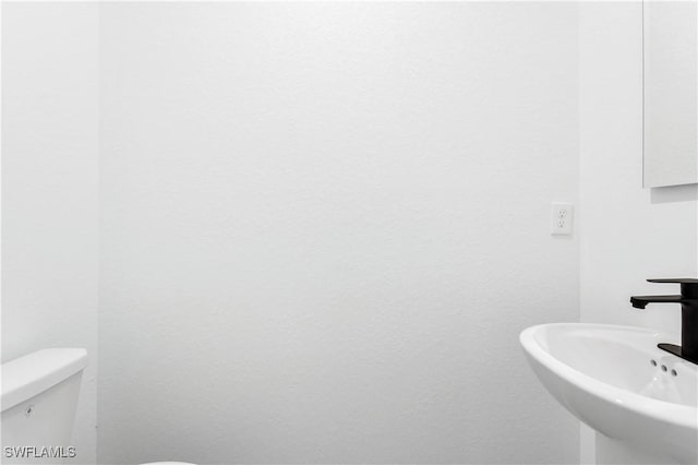 902 Magnolia Ave, Lehigh Acres, FL 33972 - bathroom with a sink and toilet