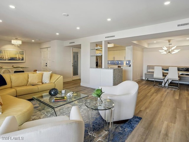 3951 Gulf Shore Blvd N Unit 1005, Naples, FL 34103 - living area featuring baseboards, light wood-style floors, recessed lighting, and a chandelier